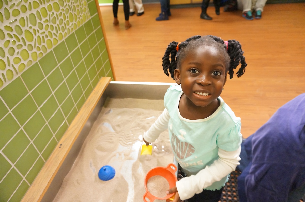 a kid playing with toys in a classroom