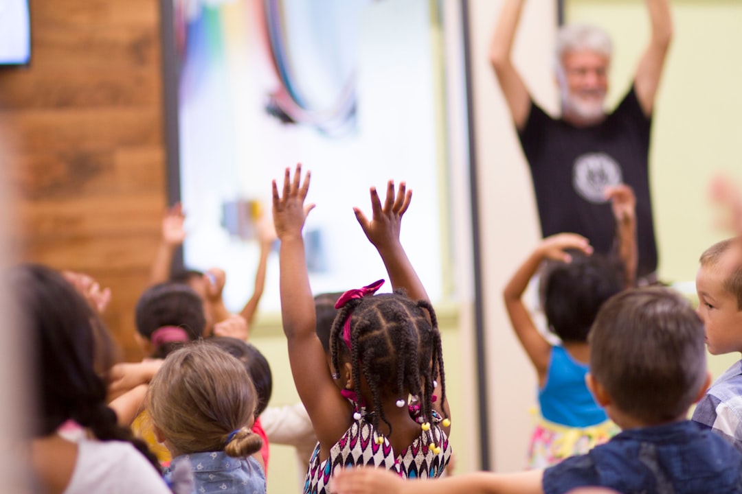 kids raising hands in a classroom